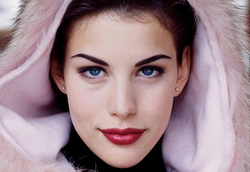 Liv Tyler in a pink outfit with a fur hoodie