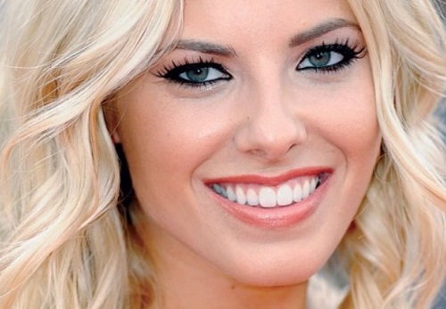 A close up of Mollie King smiling happily to the camera
