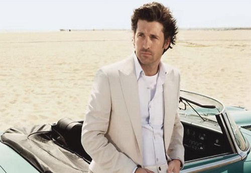 Actor Patrick Dempsey looking cool in front of a sport car