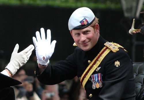 Prince Harry waving in a open horse carriage