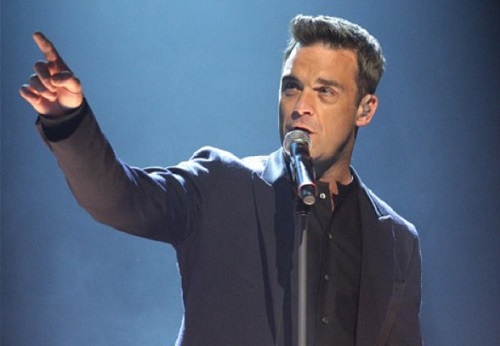 Singer Robbie Williams performing on stage