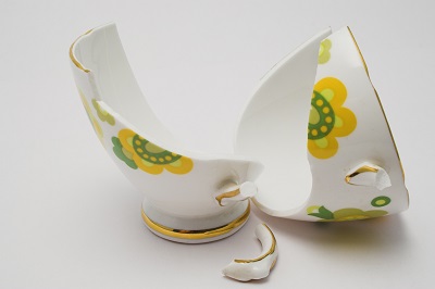 pieces of a broken fine china cup